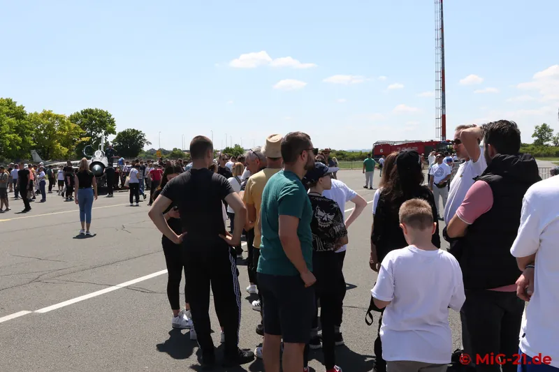 Dozens wait patiently for their chance to climb into the MiG-21's cockpit.