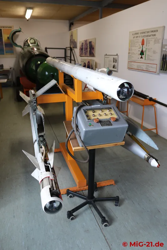 The armament on display includes cutaway models of the R-3S and RS-2US missiles, ...