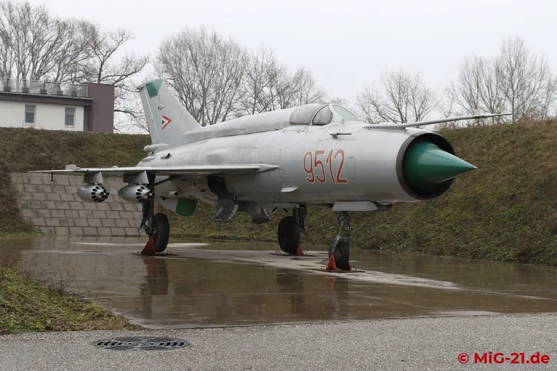 Two further MiG-21s in the open-air area stand out visually: a MiG-21MF realistically displayed in an open …
