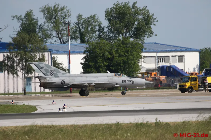 Rafale and MiG-21 taxi out of the military area onto the runway in front of us and line up on the west side.