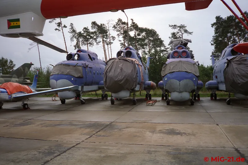 Under the tail boom of a fully painted Mi-14 "Eliminator", stored airframes can be seen that were still to be …