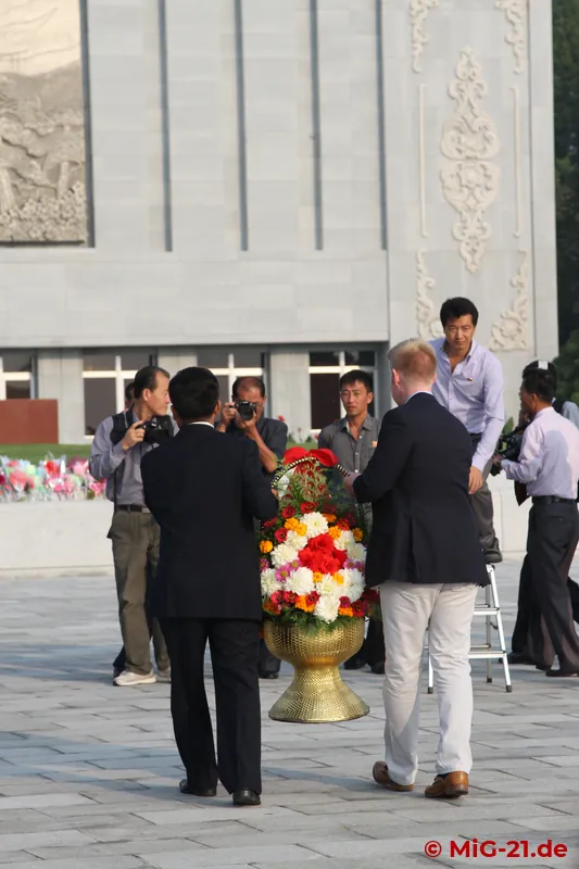 ... and flowers are laid. Only then do the buses roll to the airport, ...