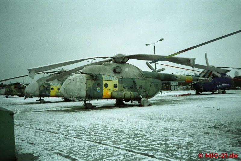 Dozens of Mi-8s stood on the flightline, ...